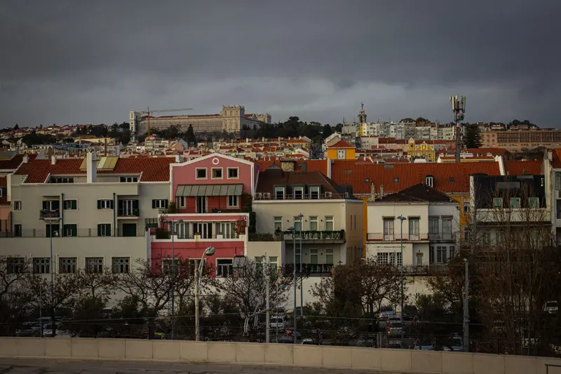 Terracotta rooftops of Lisbon under a soft sky